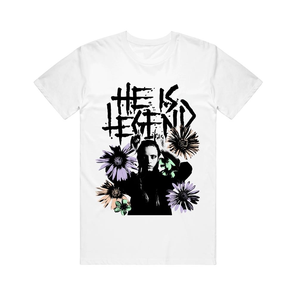 White tee. HE IS LEGEND text above 4 sunflowers surrounding a girl with fingers on her head to represents horns. 